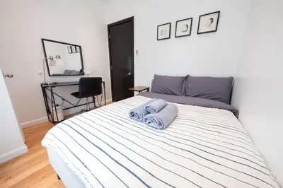 a bedroom with a bed with a towel on it at 3 BD next to Central Park in New York