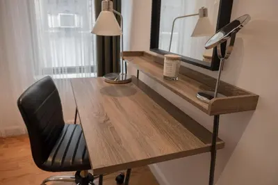 a desk with a chair and a mirror and a lamp at 3 BD next to Central Park in New York