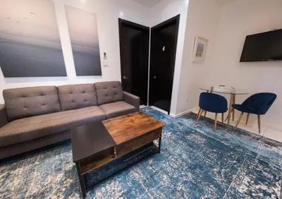 a living room with a couch and a table at 3 BD next to Central Park in New York