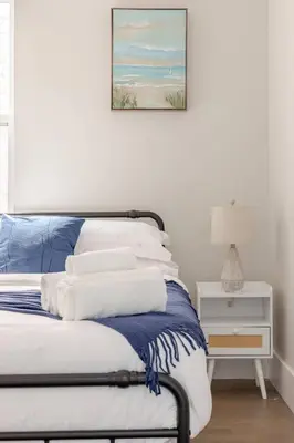 a bedroom with a bed with a picture on the wall at NYC Gateway, 30minutes from Manhattan in Jersey City