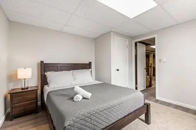 a bedroom with a bed with two towels on it at Joyful 5 Bedroom Home in Harrisburg