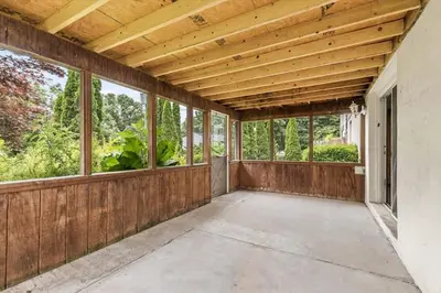 an empty porch with windows and a wooden ceiling at Joyful 5 Bedroom Home in Harrisburg