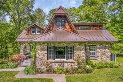 a stone house with a copper roof at Rose & Thorne in Gardiner