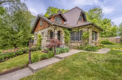 a stone house with a gambrel roof at Rose & Thorne in Gardiner