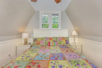 a bedroom with a bed with a colorful bedspread at Rose & Thorne in Gardiner