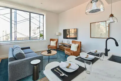 a living room with a couch and a table at Prime Hoboken Lofts in Hoboken