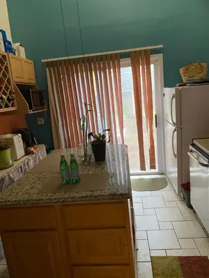 a kitchen with a counter with two bottles on it at Scenic easy go to TIMES SQUARE in North Bergen