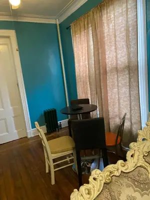 a dining room with a table and chairs and blue walls at Scenic easy go to TIMES SQUARE in North Bergen