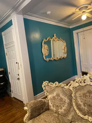 a room with a couch and a mirror on a wall at Scenic easy go to TIMES SQUARE in North Bergen