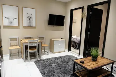 a living room with a table and a dining room at 2 BD Next to Central Park in New York