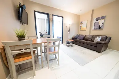 a living room with a table and a couch at 2 BD Next to Central Park in New York