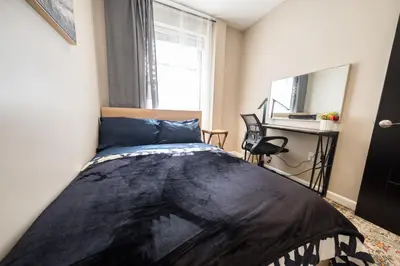 a bedroom with a bed and a desk at 2 BD Next to Central Park in New York