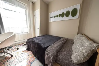 a bedroom with a bed and a desk and a window at 2 BD Next to Central Park in New York