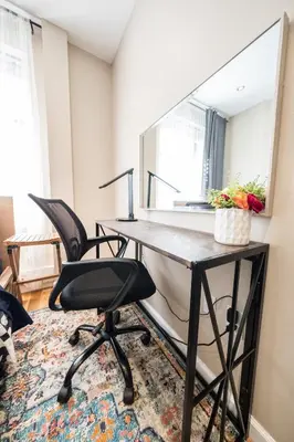 an office with a desk with two chairs and a mirror at 2 BD Next to Central Park in New York
