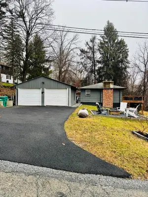 a house with a driveway and a garage at Vernon Cozy 2BD Pet-Friendly Mountain Creek in Vernon