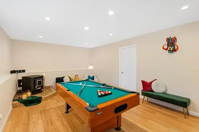 a living room with a pool table in it at Enchanted Villa in Pocono Summit