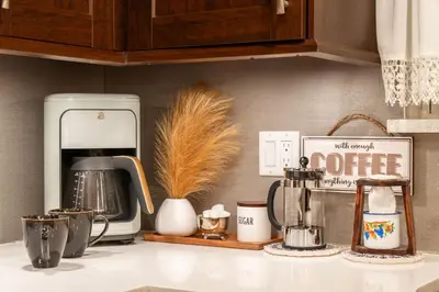 a kitchen counter with a coffee maker on a counter top at Enchanted Villa in Pocono Summit
