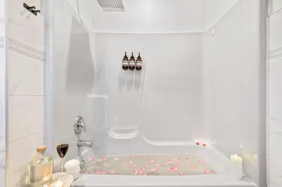 a white bath tub with two pairs of shoes in it at Enchanted Villa in Pocono Summit