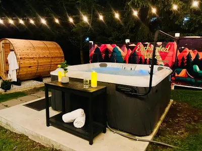 a jacuzzi tub in a yard with lights at Enchanted Villa in Pocono Summit