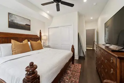 a bedroom with a large bed and a flat screen tv at Roof deck w city views - brand new 3bd 3ba in Philadelphia