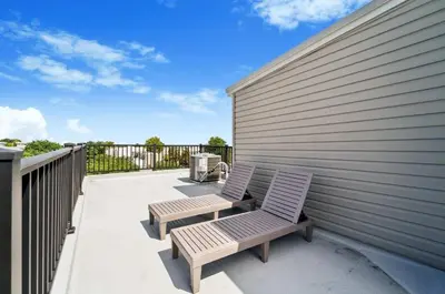 a pair of benches sitting on a patio at Roof deck w city views - brand new 3bd 3ba in Philadelphia