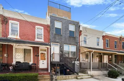 a row of brick houses in a city at Roof deck w city views - brand new 3bd 3ba in Philadelphia