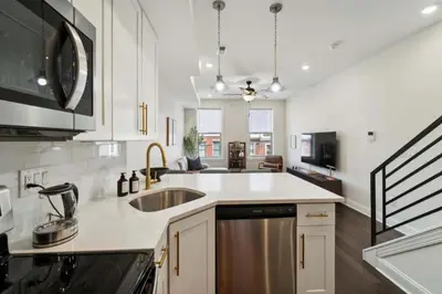 a kitchen with a sink and a counter top at Roof deck w city views - brand new 3bd 3ba in Philadelphia
