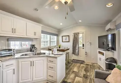 a kitchen with white cabinets and a sink at Clydesdale Cottage by Equestrian House in Pleasant Mount