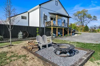 a fire pit in front of a house at Paceful & Stylish Rural Retreat in Pine Grove