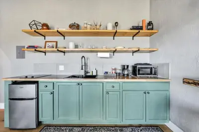 a kitchen with blue cabinets and a sink at Paceful & Stylish Rural Retreat in Pine Grove