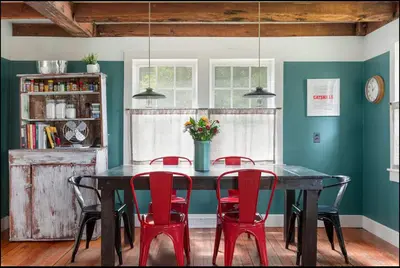 a dining room with a black table and red chairs at Private Creek and Large Yard at the Coziest Cabin in the Catskills in Margaretville