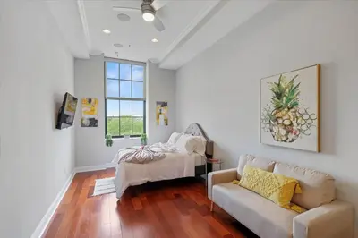 a room with a bed and a couch and a window at Upscale NoLibs XL Studio - Pool & Gym in Philadelphia