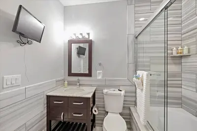 a bathroom with a toilet and a sink and a shower at Upscale NoLibs XL Studio - Pool & Gym in Philadelphia