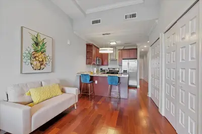 a living room with a couch and a kitchen at Upscale NoLibs XL Studio - Pool & Gym in Philadelphia