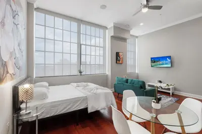 a living room with a bed and a table and chairs at Modern NoLibs Studio - Pool & Gym in Philadelphia