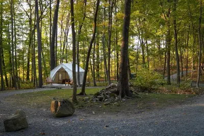 a white tent in the middle of a forest at Heavens Landing at Moon Valley Campground in Vernon Township