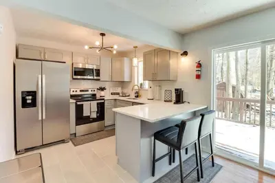 a kitchen with stainless steel appliances and a large window at Family fun at Casa Ledges in Tobyhanna
