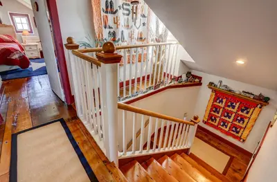 a staircase with white railings in a home at Osceola Mill House Bed and Breakfast in Gordonville
