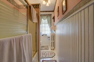 a bathroom with a hallway with a shower and a toilet at Osceola Mill House Bed and Breakfast in Gordonville