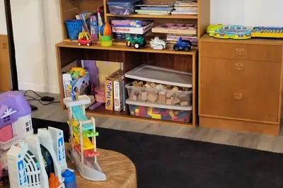 a room with a book shelf with toys on it at Serenity On The Lehigh River in Thornhurst