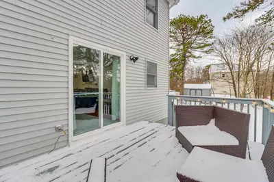 a porch with a bench on the side of a house at Chic Pocono Hideaway with Private Indoor Sauna in Long Pond