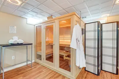 a room with a closet with a robe in it at Chic Pocono Hideaway with Private Indoor Sauna in Long Pond