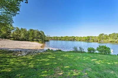a view of a lake with trees in the background at Chic Pocono Hideaway with Private Indoor Sauna in Long Pond