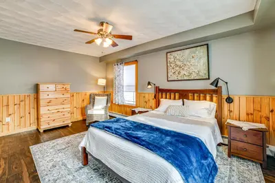 a bedroom with a bed and a ceiling fan at Lisle Apt 4 Mi to Dorchester Lake! in Lisle