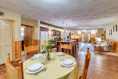 a dining room and kitchen with a table and chairs at Lisle Apt 4 Mi to Dorchester Lake! in Lisle