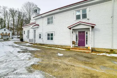 a white house with a purple door and a driveway at Lisle Apt 4 Mi to Dorchester Lake! in Lisle