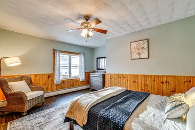 a bedroom with a bed and a ceiling fan at Lisle Apt 4 Mi to Dorchester Lake! in Lisle