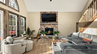 a living room with a couch and a fireplace at Lakeview Sunset Heaven by AvantStay Waterfront Home • Hot Tub Game Room Discounted Ski Tickets in Blakeslee