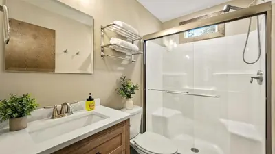 a bathroom with a toilet and a sink and a shower at Lakeview Sunset Heaven by AvantStay Waterfront Home • Hot Tub Game Room Discounted Ski Tickets in Blakeslee
