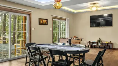 a dining room with a table and chairs at Lakeview Sunset Heaven by AvantStay Waterfront Home • Hot Tub Game Room Discounted Ski Tickets in Blakeslee